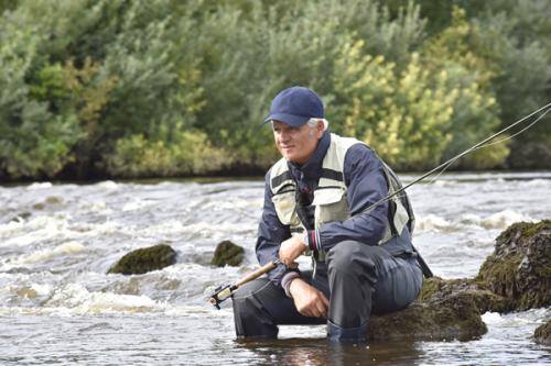 bigstock-Fly-fisherman-waiting-with-fis-148668968